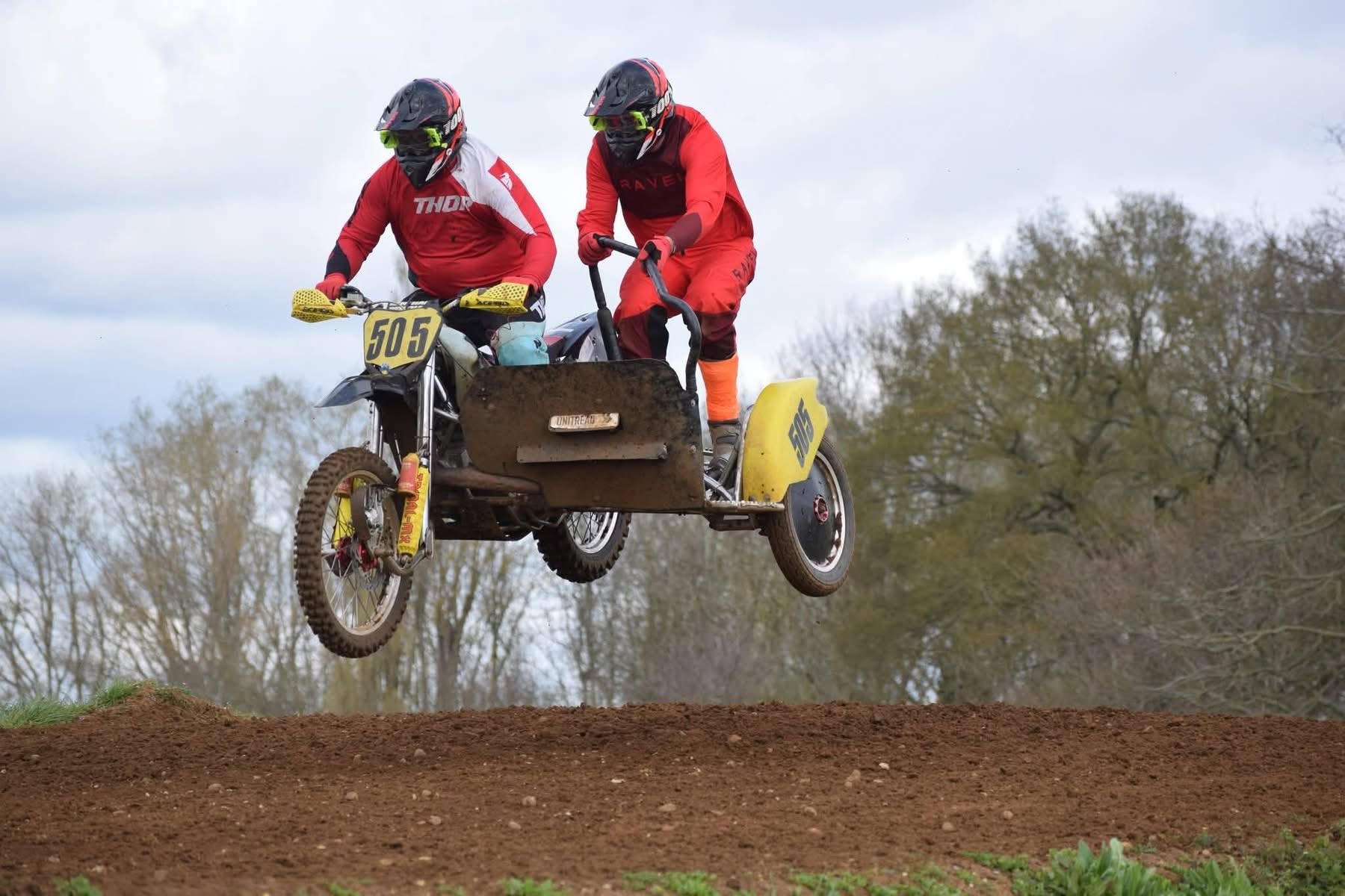 Sidecar team airborne over the dirt